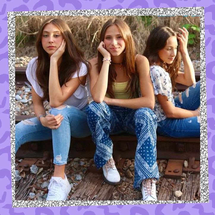 Gabriella, Grace, and Scarlett of Hello Sister posing on train tracks